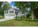 Beautifully maintained two-story home with an attached two-car garage and lush front lawn and garden at 30 W Fork Way, Temple, GA 30179