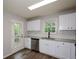 Bright kitchen featuring white cabinets, stainless appliances, and wood-look floors at 30 W Fork Way, Temple, GA 30179