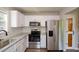 Updated kitchen featuring stainless appliances, granite counters, and white cabinets at 30 W Fork Way, Temple, GA 30179