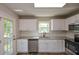 Updated kitchen featuring white cabinets, stainless steel appliances, and granite countertops at 30 W Fork Way, Temple, GA 30179