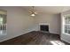 Living room showcasing a fireplace, ceiling fan, and wood-look floors at 30 W Fork Way, Temple, GA 30179