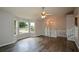 Bright living room featuring large windows, ceiling fan, and wood-look floors at 30 W Fork Way, Temple, GA 30179