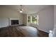Inviting living room featuring hardwood floors, a fireplace, and large windows allowing natural light to fill the space at 30 W Fork Way, Temple, GA 30179