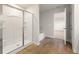 Modern bathroom featuring a glass shower, bathtub, and a door leading to another room at 4028 Trimrose Ct, Atlanta, GA 30349