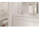 Bright bathroom with double vanity, white cabinetry, and separate tub at 4028 Trimrose Ct, Atlanta, GA 30349