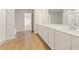 Bright bathroom featuring double sink vanity with modern fixtures, a mirror, and walk-in shower at 4028 Trimrose Ct, Atlanta, GA 30349