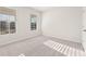 Light-filled bedroom with plush carpet, neutral walls, and two large windows offering ample natural light at 4028 Trimrose Ct, Atlanta, GA 30349
