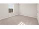 A bright bedroom with neutral carpet, one window, and base trim at 4028 Trimrose Ct, Atlanta, GA 30349
