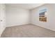Neutral carpeted bedroom with a window and base trim at 4028 Trimrose Ct, Atlanta, GA 30349