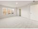 Spacious bedroom with plush carpeting, three windows providing natural light, and a closet door at 4028 Trimrose Ct, Atlanta, GA 30349