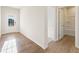 Bright entryway with wood-look flooring, leading to a bathroom and featuring a glass-paned front door at 4028 Trimrose Ct, Atlanta, GA 30349