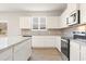 Stylish kitchen featuring granite countertops, stainless steel appliances, white cabinets, and island seating at 4028 Trimrose Ct, Atlanta, GA 30349