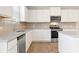 Bright kitchen boasts white cabinets, granite countertops, stainless steel appliances, and a stylish tile backsplash at 4028 Trimrose Ct, Atlanta, GA 30349