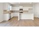 Modern kitchen features white cabinets, stainless steel appliances, tile backsplash, and an island with seating at 4028 Trimrose Ct, Atlanta, GA 30349