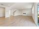 Open-concept living area with luxury vinyl plank flooring, fireplace, staircase and sliding glass door access at 4028 Trimrose Ct, Atlanta, GA 30349