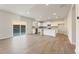 Bright, open-concept living space with luxury vinyl plank flooring and access to the kitchen and outdoor patio at 4028 Trimrose Ct, Atlanta, GA 30349