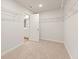 A spacious walk-in closet with carpet, wire shelving, and a door to the Primary bathroom at 4028 Trimrose Ct, Atlanta, GA 30349