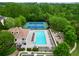 Aerial view of community pool, tennis courts, playground, and manicured grounds at 4195 Settlers Grove Rd, Cumming, GA 30028