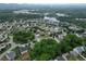 Aerial view of the neighborhood with mature trees and winding streets at 4195 Settlers Grove Rd, Cumming, GA 30028