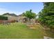 Fenced backyard features a nice lawn, mature tree, and covered patio at 4195 Settlers Grove Rd, Cumming, GA 30028