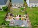 Aerial view of fenced backyard with beautiful garden, patio, play set, and mature trees at 4195 Settlers Grove Rd, Cumming, GA 30028
