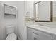 Cozy half bath features updated vanity with marble countertop, updated fixtures, and tile detail at 4195 Settlers Grove Rd, Cumming, GA 30028