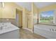 Bright bathroom with double sinks, tiled backsplash, soaking tub, and separate shower with glass doors at 4195 Settlers Grove Rd, Cumming, GA 30028