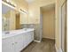 Bathroom featuring double sink vanity, tiled backsplash, and glass-enclosed shower at 4195 Settlers Grove Rd, Cumming, GA 30028