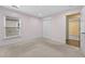 Light-filled bedroom with a closet, neutral carpet, and light lilac walls at 4195 Settlers Grove Rd, Cumming, GA 30028