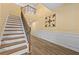 Inviting foyer featuring a staircase, hardwood floors, and elegant wall accents at 4195 Settlers Grove Rd, Cumming, GA 30028