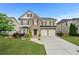 Charming two-story home with stone accents, two-car garage, and beautifully landscaped front yard at 4195 Settlers Grove Rd, Cumming, GA 30028