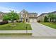 Beautiful two-story home featuring a well-manicured lawn, stone accents, and a two-car garage at 4195 Settlers Grove Rd, Cumming, GA 30028