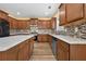 Spacious kitchen boasts stainless appliances, custom backsplash, wood cabinets, and marble countertops at 4195 Settlers Grove Rd, Cumming, GA 30028