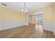 Bright, open living room with modern chandelier and hardwood floors at 4195 Settlers Grove Rd, Cumming, GA 30028