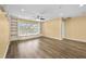 Bright room featuring custom built-ins, hardwood floors, and large windows at 4195 Settlers Grove Rd, Cumming, GA 30028