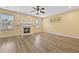 Bright living room featuring a cozy fireplace and hardwood flooring at 4195 Settlers Grove Rd, Cumming, GA 30028