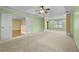 Large carpeted main bedroom with tray ceilings offers ample natural light and spacious layout at 4195 Settlers Grove Rd, Cumming, GA 30028