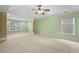 Large carpeted main bedroom boasts natural light, tray ceilings, and ceiling fan at 4195 Settlers Grove Rd, Cumming, GA 30028