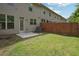 Spacious backyard with a patio area and wood fence, perfect for outdoor entertaining and privacy at 5527 Fairhaven Pl, Fairburn, GA 30213