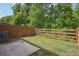 Backyard features a well-maintained lawn and partially fenced yard perfect for outdoor activities at 5527 Fairhaven Pl, Fairburn, GA 30213