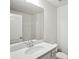 Bathroom with a large mirror, single sink vanity and toilet at 5527 Fairhaven Pl, Fairburn, GA 30213