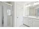 Light filled bathroom with large mirror, double sink vanity, and glass enclosed shower at 5527 Fairhaven Pl, Fairburn, GA 30213