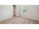 Bedroom featuring carpet, an open closet, and a window at 5527 Fairhaven Pl, Fairburn, GA 30213