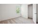 Bedroom with plush carpet, open closet, and view from the window at 5527 Fairhaven Pl, Fairburn, GA 30213