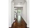Inviting hallway features gleaming hardwood floors and leads to a bright, open living space at 5527 Fairhaven Pl, Fairburn, GA 30213