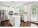Bright, open kitchen featuring stainless steel appliances and a central island with pendant lighting at 5527 Fairhaven Pl, Fairburn, GA 30213