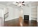 Spacious living room showcases a fireplace, built-in shelving, and gleaming hardwood floors at 5527 Fairhaven Pl, Fairburn, GA 30213