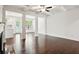 Open-concept living room boasts coffered ceiling, dark hardwood floors, and natural light at 5527 Fairhaven Pl, Fairburn, GA 30213