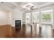 Elegant living room with coffered ceilings, fireplace, and open access to a modern kitchen at 5527 Fairhaven Pl, Fairburn, GA 30213