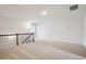 Upstairs loft area features neutral carpeting, staircase, and ample natural light at 5527 Fairhaven Pl, Fairburn, GA 30213